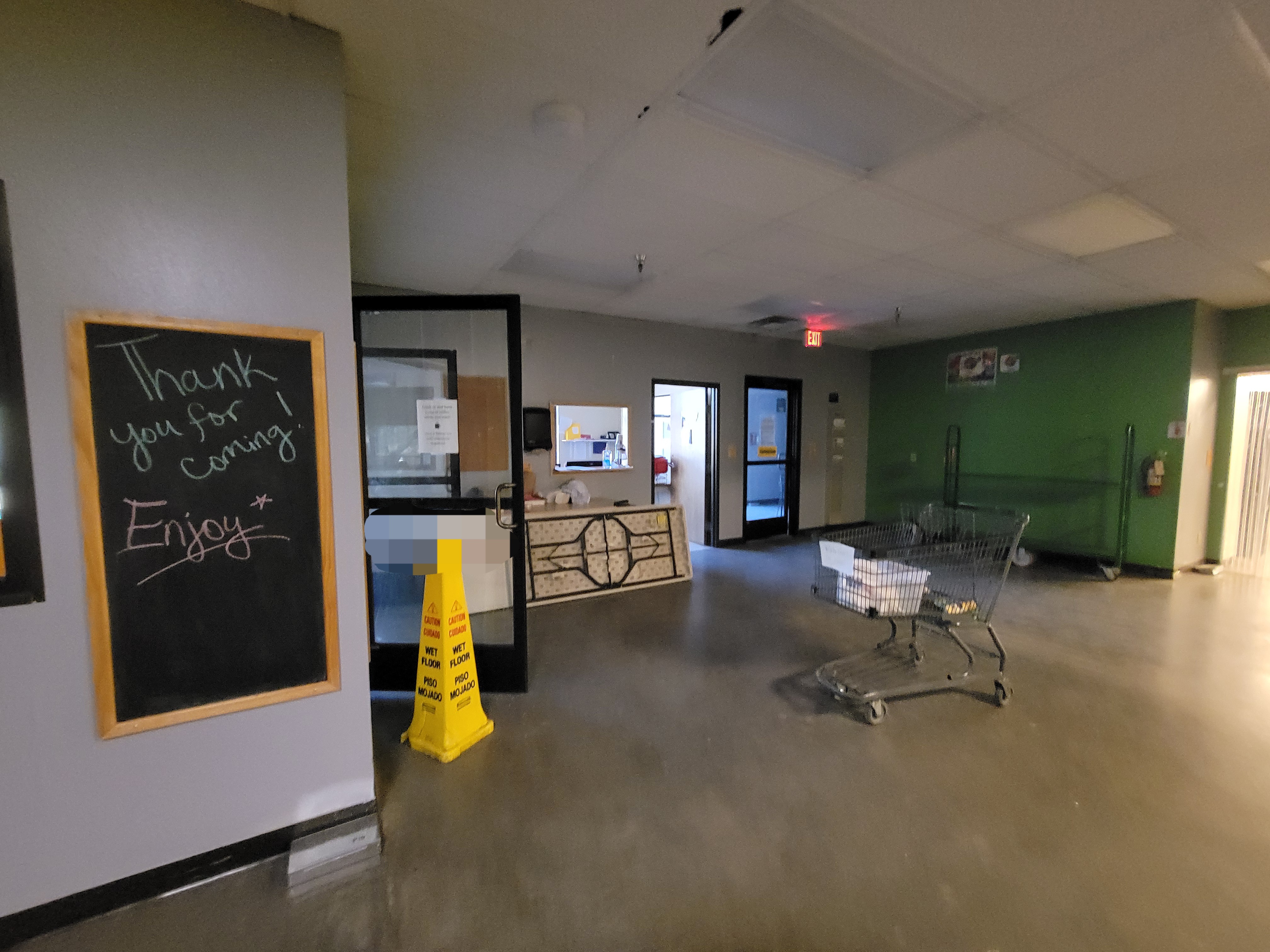 Mini former food bank grocery store area with entrances to different areas and miscellaneous items scattered about.